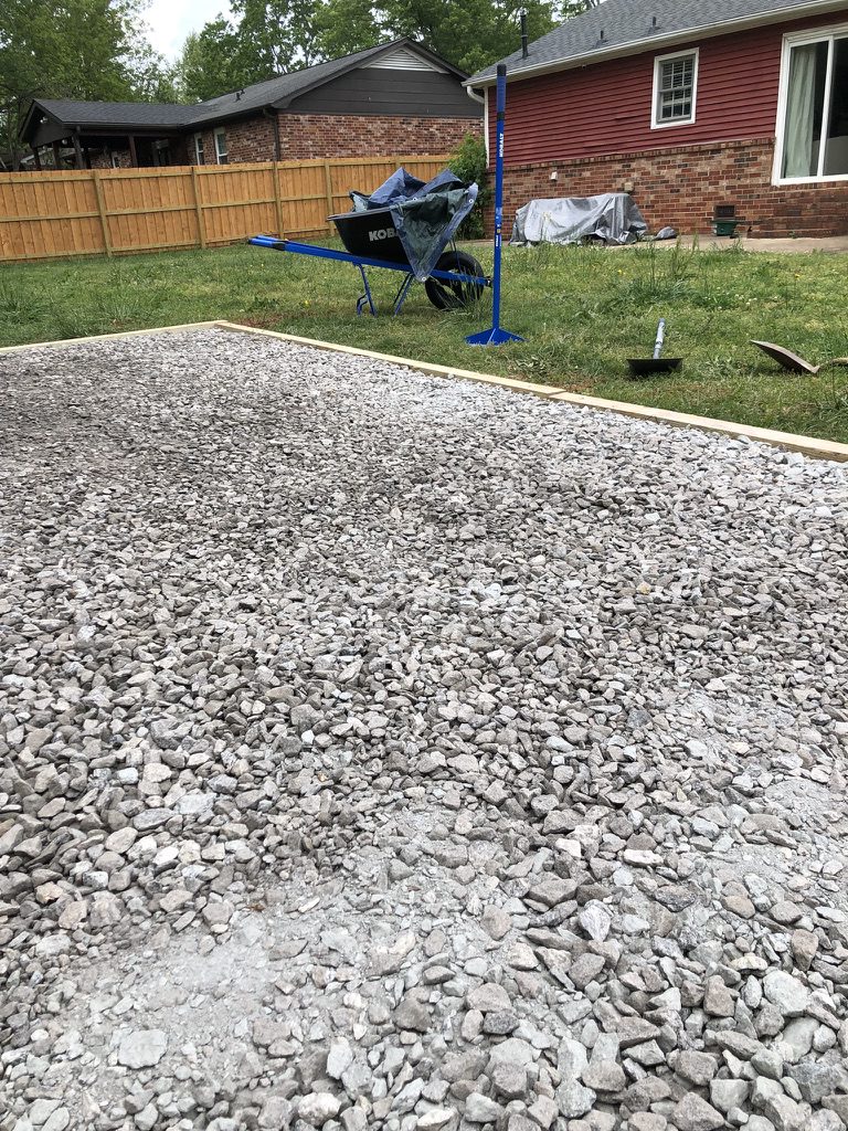 Laser-leveled gravel shed foundation with pressure treated timber border